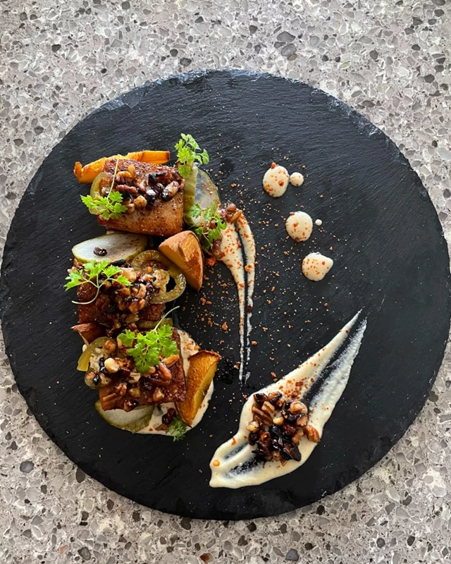 Pork belly, Apple cinnamon aioli, smoked ontario peaches, house pickles, maple toasted pecans, sriracha dust, chervil.